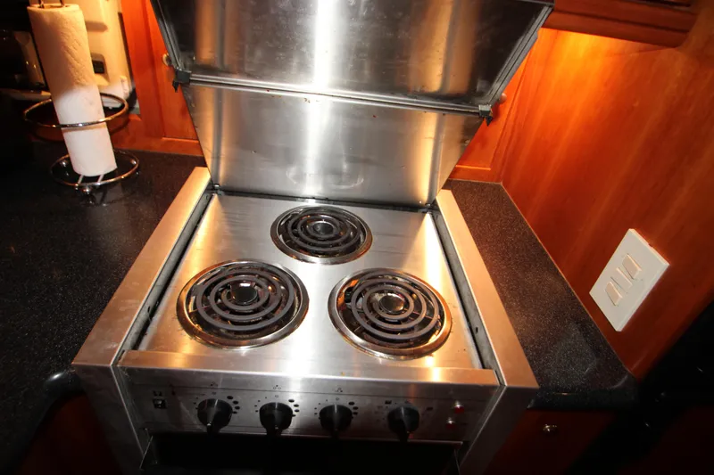 Slide: The Image of Stainless steel stove with three burners in a 2002 Silverton 43 Motor Yacht kitchen. - 29