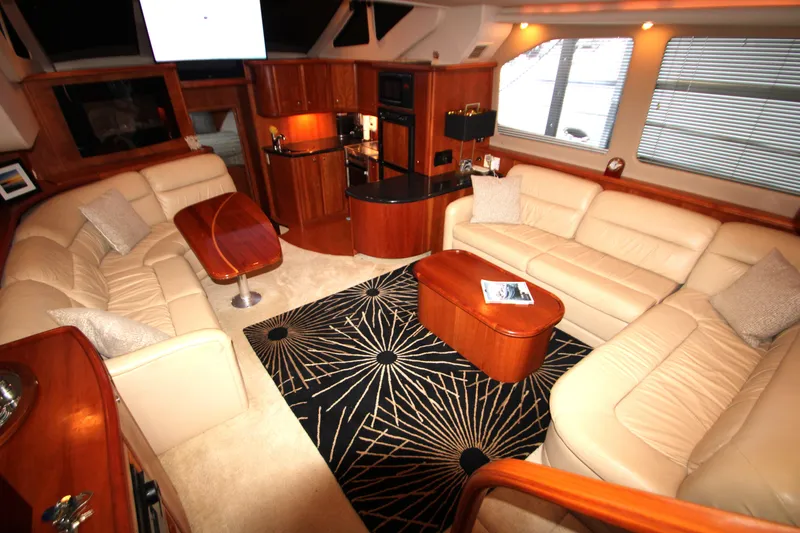 Slide: The Image of 2002 Silverton 43 Motor Yacht on a serene lake with lush green shoreline. - 3