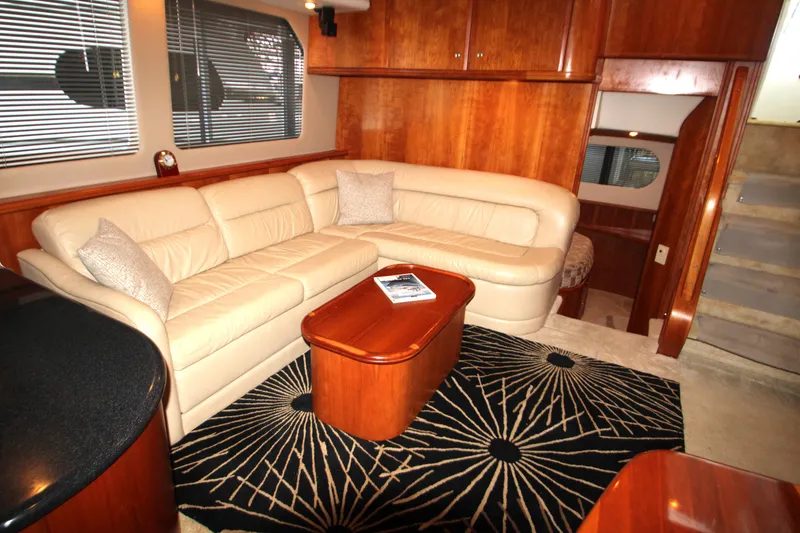 Slide: The Image of Luxurious interior of 2002 Silverton 43 Motor Yacht with beige leather seating and wooden accents. - 32