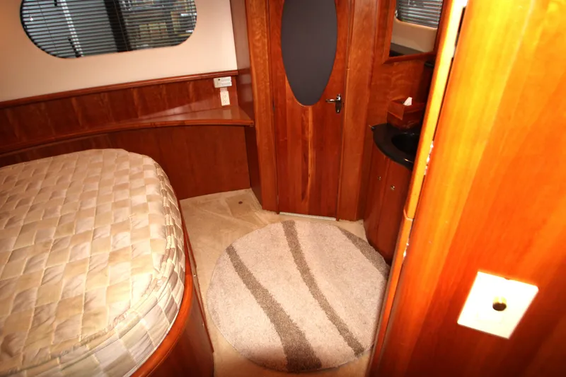 Slide: The Image of Interior of 2002 Silverton 43 Motor Yacht with wood paneling and circular rug. - 35