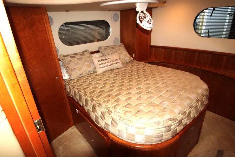 Slide: The Image of Luxurious bedroom interior of 2002 Silverton 43 Motor Yacht with cozy bedding and wooden accents. - 36