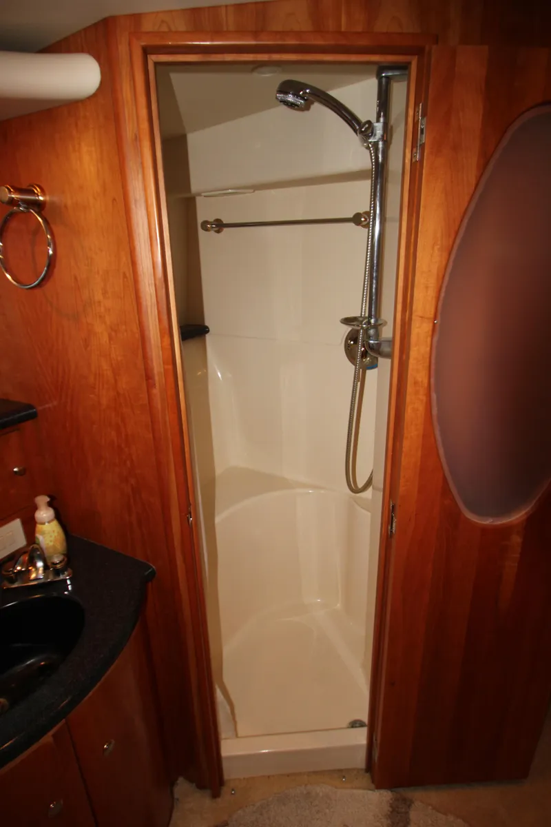 Slide: The Image of Shower area in 2002 Silverton 43 Motor Yacht with wooden cabinetry and modern fixtures. - 41