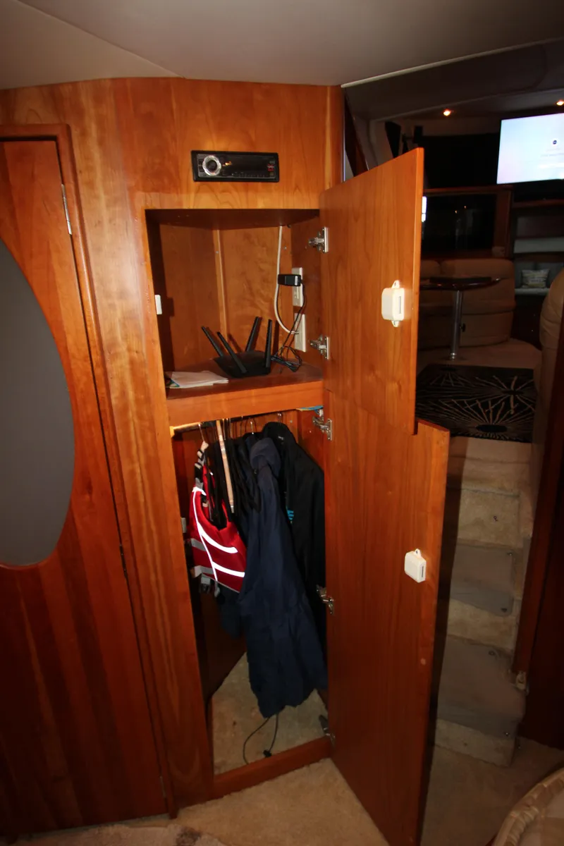 Slide: The Image of 2002 Silverton 43 Motor Yacht interior closet with jackets and electronic equipment. - 43