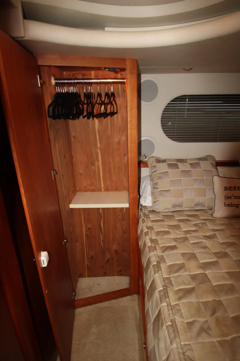 Slide: The Image of Cozy bedroom in 2002 Silverton 43 Motor Yacht with wooden closet and bed. - 44