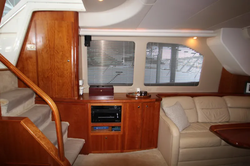 Slide: The Image of Luxurious interior of 2002 Silverton 43 Motor Yacht with wood paneling and plush seating. - 45