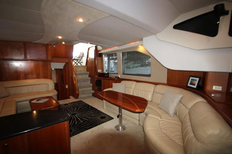 Slide: The Image of Luxurious interior of 2002 Silverton 43 Motor Yacht with plush seating and elegant wood finishes. - 7
