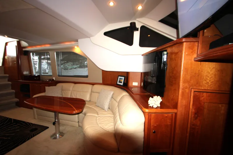 Slide: The Image of Luxurious interior of 2002 Silverton 43 Motor Yacht with plush seating and wooden accents. - 8
