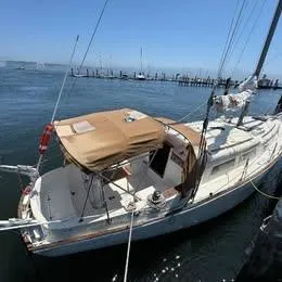 Slide: The Image of 1977 Seafarer 38 sailboat docked at marina under clear blue sky. - 1