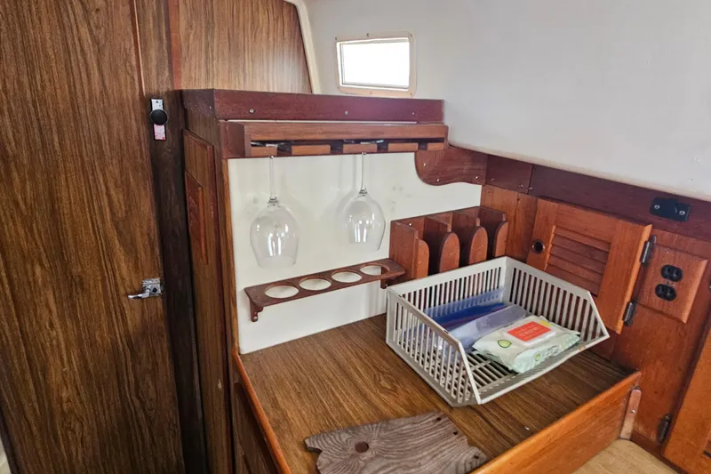 Slide: The Image of Interior of a 1977 Seafarer 38 sailboat with wooden cabinetry and storage. - 14