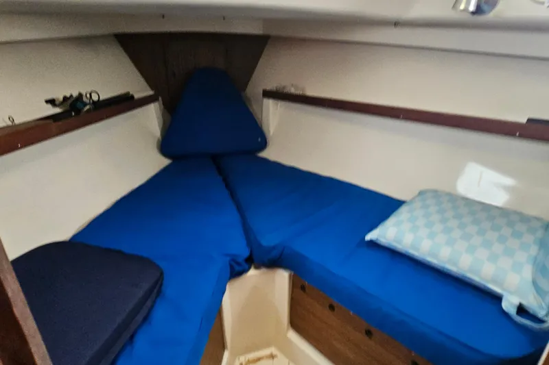 Slide: The Image of Cozy cabin interior of 1977 Seafarer 38 sailboat with blue cushions and wooden accents. - 17