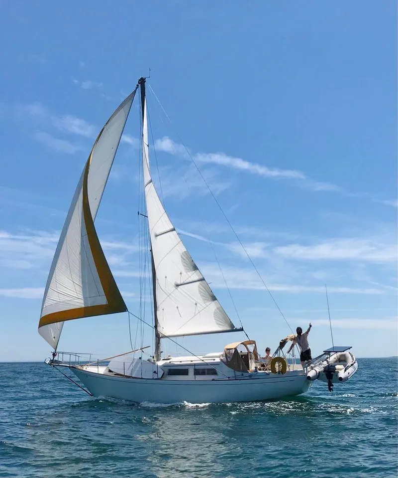 Slide: The Image of 1977 Seafarer 38 sailboat cruising on open sea under clear blue sky. - 2