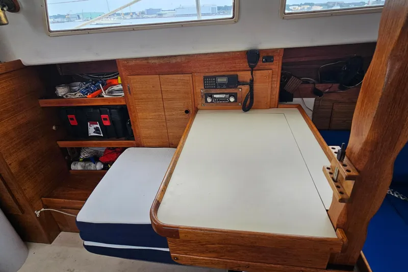 Slide: The Image of 1977 Seafarer 38 cabin interior with navigation table and storage shelves. - 20