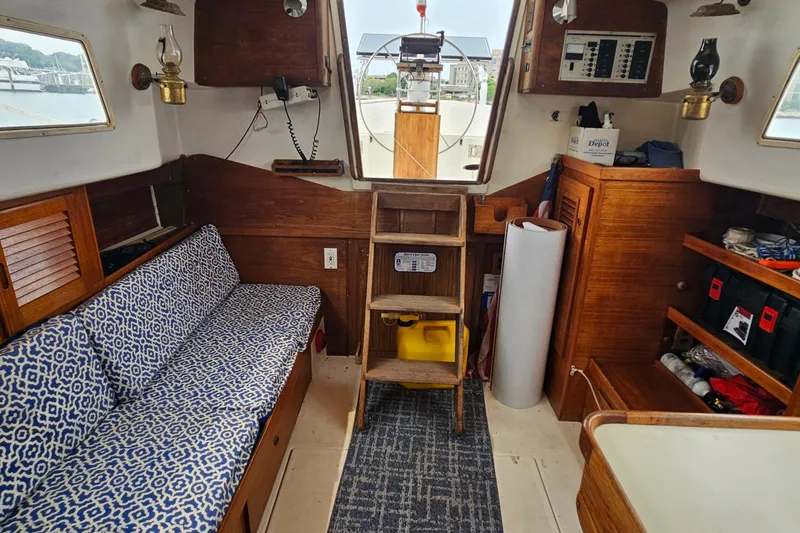 Slide: The Image of Interior of a 1977 Seafarer 38 sailboat with wooden furnishings and nautical decor. - 23