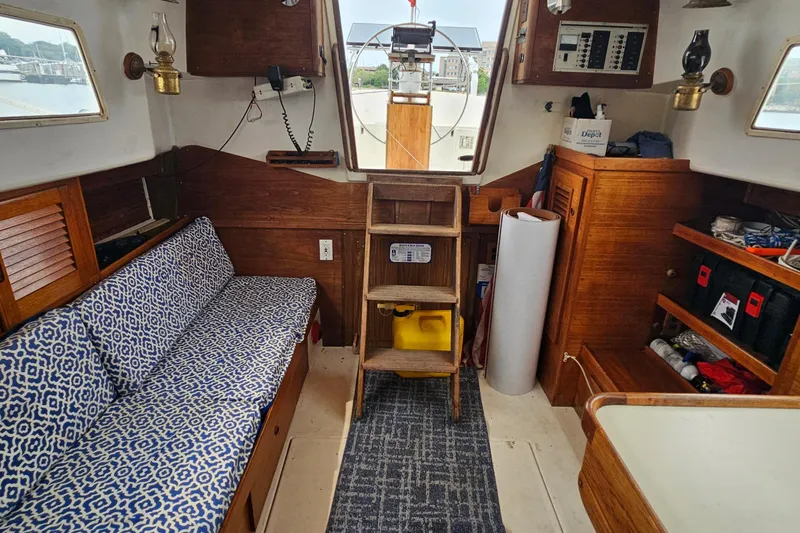 Slide: The Image of 1977 Seafarer 38 yacht interior with wooden furnishings and patterned seating. - 24