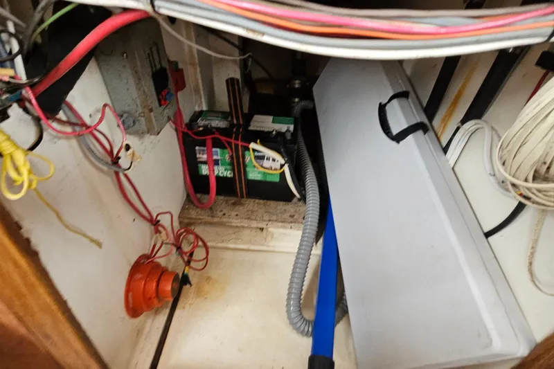 Slide: The Image of Electrical wiring and battery setup inside a 1977 Seafarer 38 boat. - 25