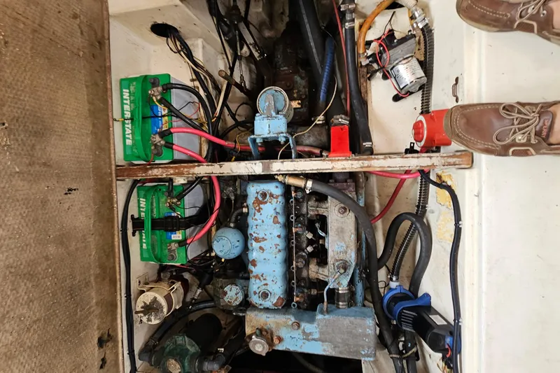 Slide: The Image of Engine compartment of a 1977 Seafarer 38 sailboat with visible batteries and wiring. - 26