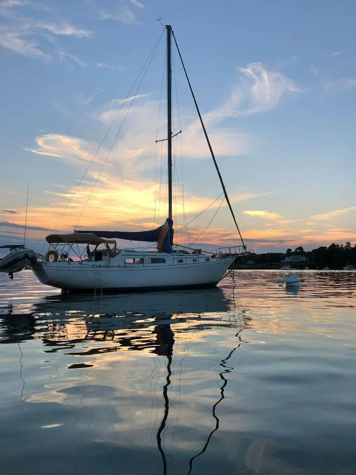Slide: The Image of 1977 Seafarer 38 sailboat at sunset on calm water. - 3