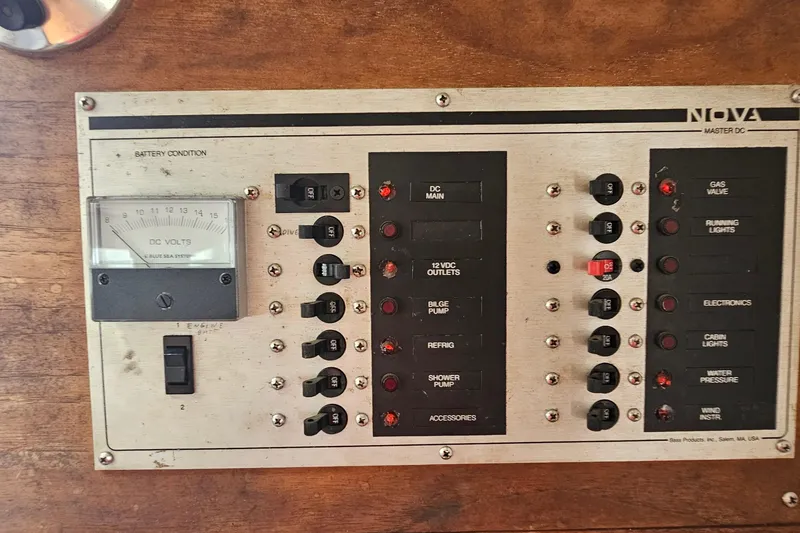 Slide: The Image of Electrical control panel on a 1977 Seafarer 38 boat, featuring switches and a voltmeter. - 30