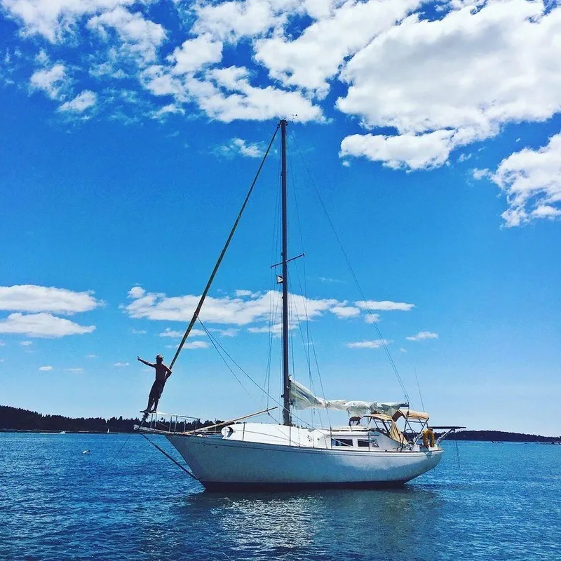 Slide: The Image of 1977 Seafarer 38 sailboat on calm water under a bright blue sky. - 4