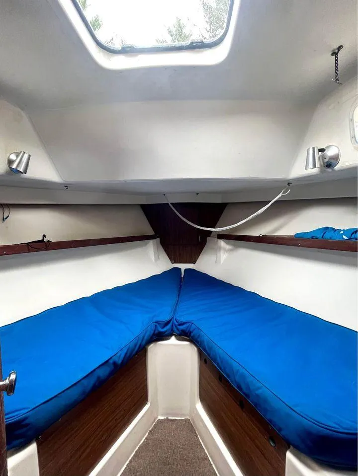 Slide: The Image of Interior cabin of 1977 Seafarer 38 sailboat with blue cushions and wooden accents. - 7