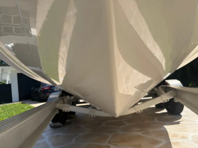 Slide: The Image of 2023 Robalo R222 boat hull on trailer, close-up view. - 11