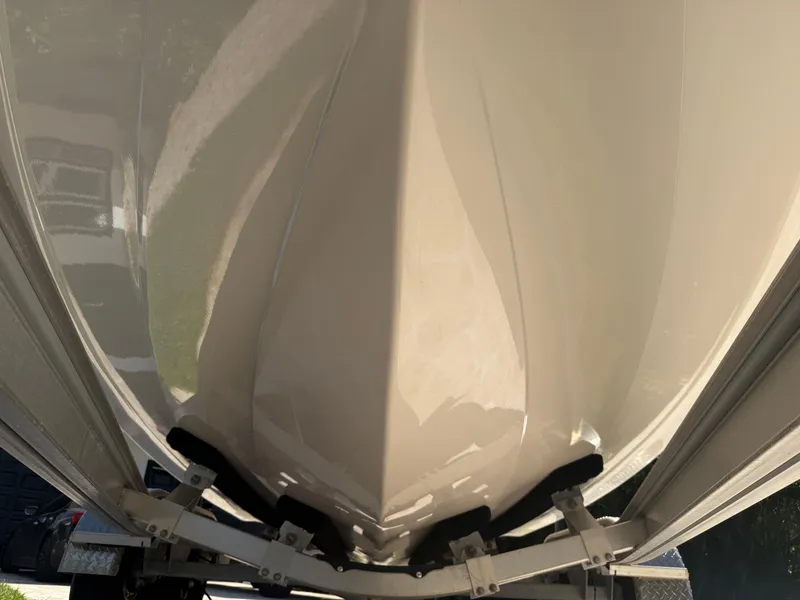 Slide: The Image of 2023 Robalo R222 boat hull on trailer, close-up view. - 12