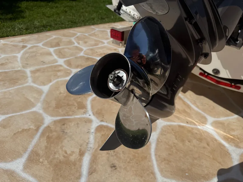 Slide: The Image of 2023 Robalo R222 boat propeller on stone pavement background. - 14