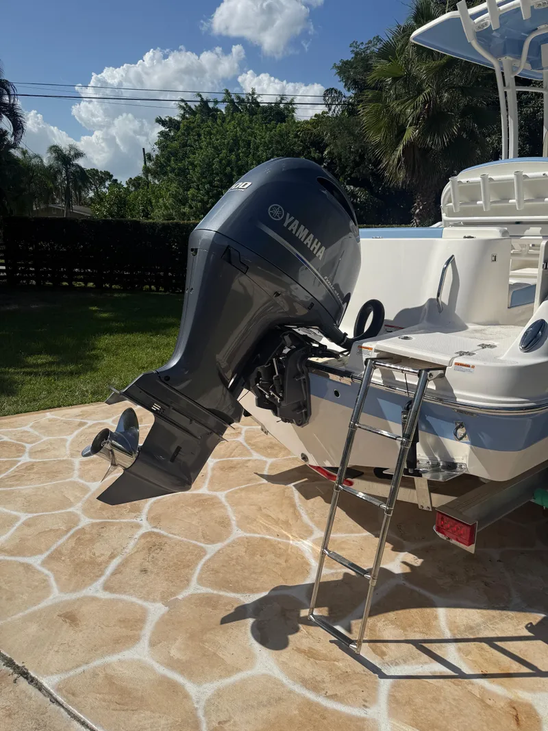 Slide: The Image of 2023 Robalo R222 boat with Yamaha outboard motor on a sunny day. - 15