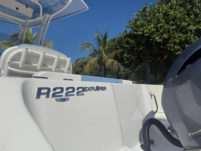Slide: The Image of 2023 Robalo R222 Explorer boat with palm trees in the background. - 18