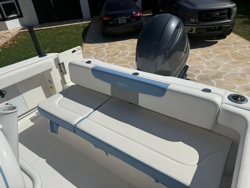 Slide: The Image of 2023 Robalo R222 boat interior with cushioned seating and Yamaha outboard motor. - 21