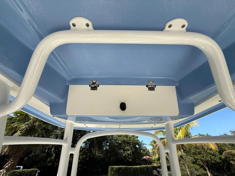 Slide: The Image of 2023 Robalo R222 boat T-top with blue interior and white frame. - 27