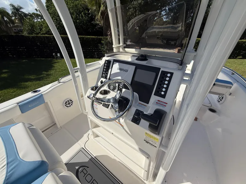 Slide: The Image of 2023 Robalo R222 boat cockpit with steering wheel and control panel. - 32