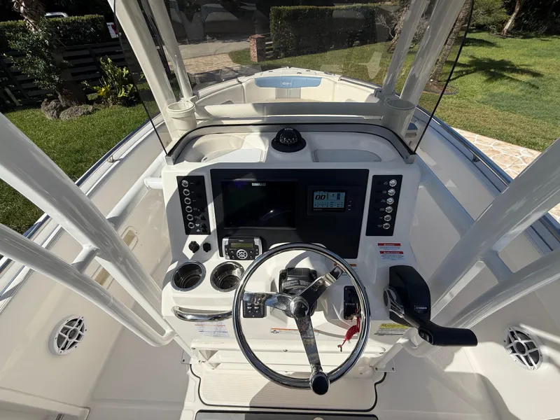 Slide: The Image of 2023 Robalo R222 boat dashboard with steering wheel and navigation controls. - 35