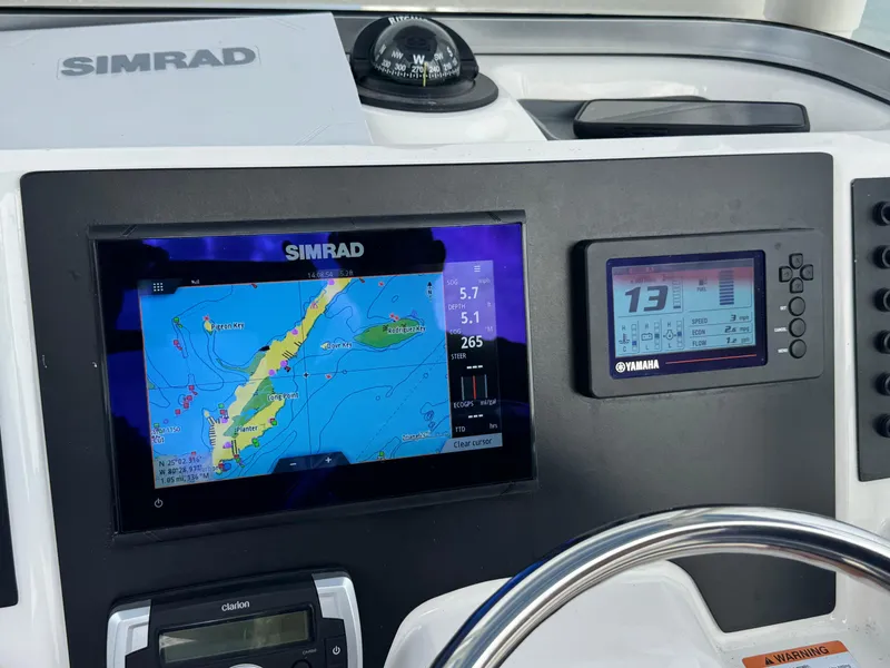 Slide: The Image of Dashboard of 2023 Robalo R222 boat with Simrad and Yamaha displays. - 36