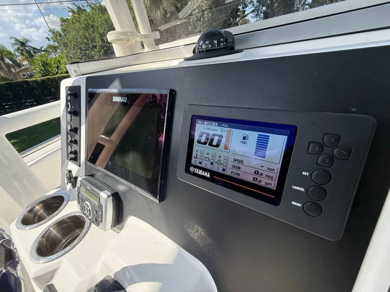 Slide: The Image of 2023 Robalo R222 boat dashboard with Simrad and Yamaha displays. - 37