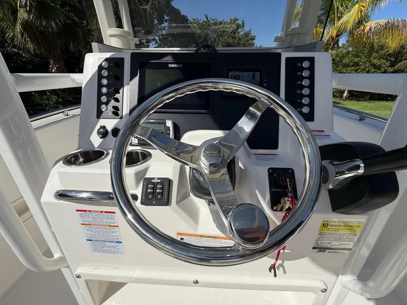 Slide: The Image of 2023 Robalo R222 boat dashboard with steering wheel and control panel. - 42