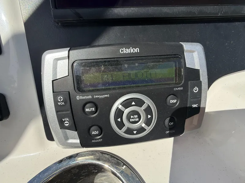 Slide: The Image of Clarion audio system on 2023 Robalo R222 boat dashboard. - 44