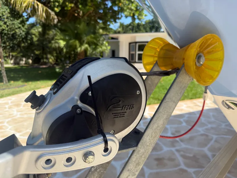 Slide: The Image of Close-up of a 2023 Robalo R222 boat trailer winch and roller on a sunny day. - 58
