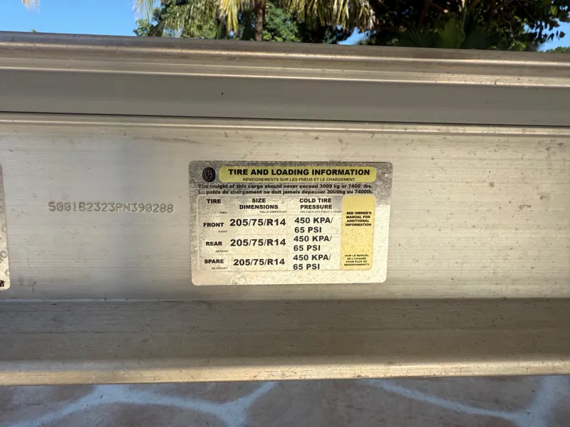 Slide: The Image of Tire and loading information label on 2023 Robalo R222 boat trailer. - 60