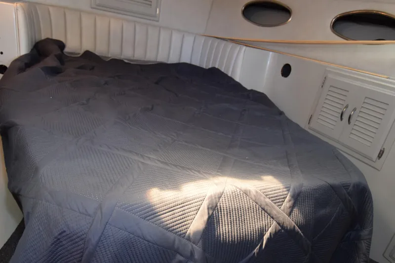 Slide: The Image of Interior cabin of 1988 Mediterranean 38 Convertible with bed and portholes. - 11