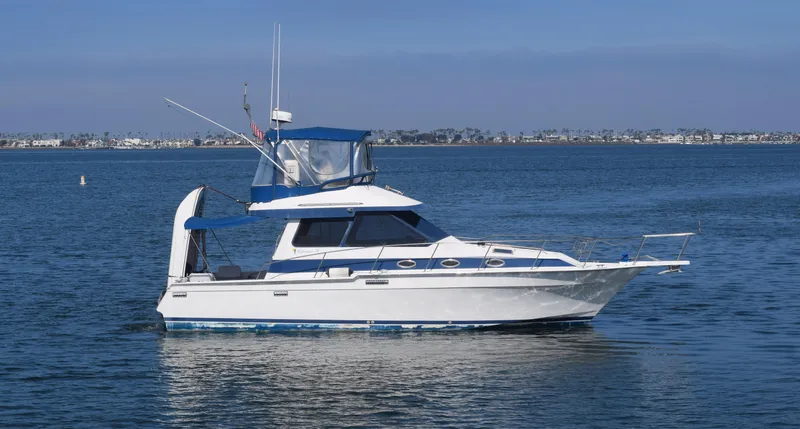 Slide: The Image of 1988 Mediterranean 38 Convertible yacht on calm blue water, clear sky background. - 14