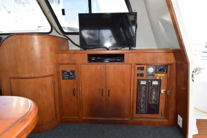 Slide: The Image of Interior of 1988 Mediterranean 38 Convertible yacht with wooden cabinetry and control panel. - 15