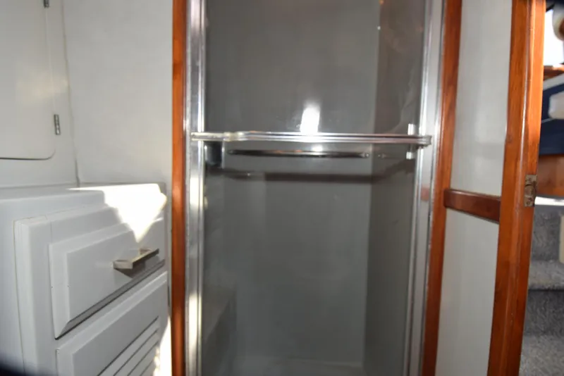Slide: The Image of 1988 Mediterranean 38 Convertible yacht interior with shower and storage. - 19