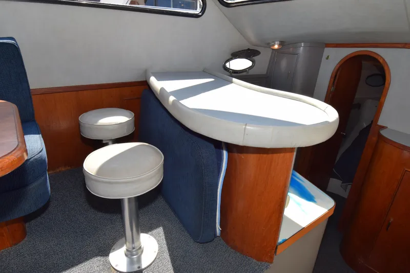 Slide: The Image of Interior of 1988 Mediterranean 38 Convertible yacht with bar and seating area. - 2