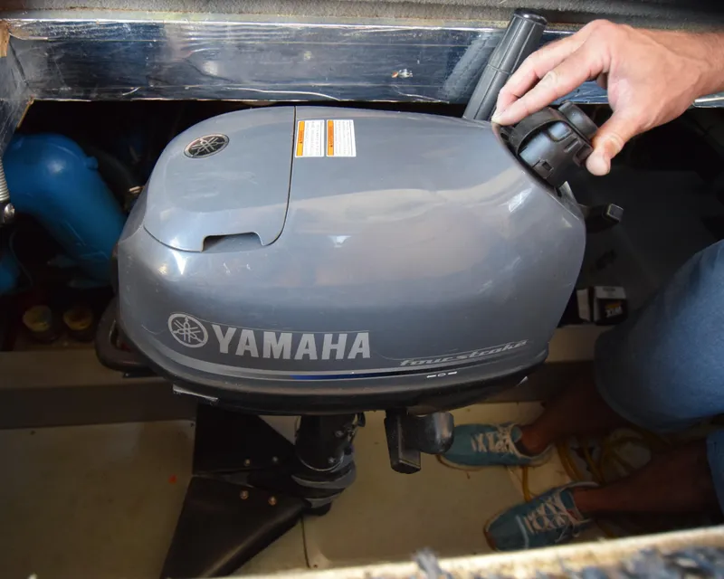 Slide: The Image of Yamaha outboard motor on 1988 Mediterranean 38 Convertible boat, with person adjusting controls. - 22