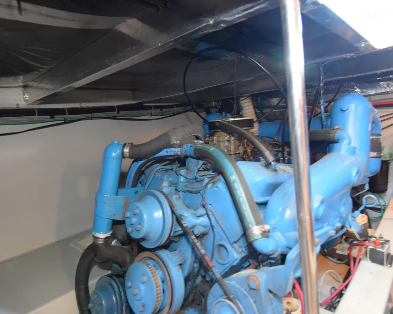 Slide: The Image of Engine room of 1988 Mediterranean 38 Convertible boat with blue machinery and wiring. - 25