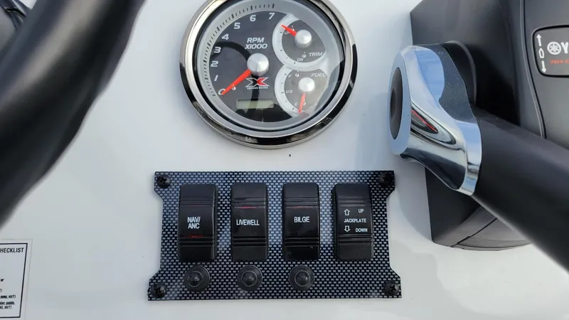Slide: The Image of Dashboard of 2025 Xpress Skiff 185 with Yamaha Vmax 115 SHO, featuring RPM gauge and control switches. - 10