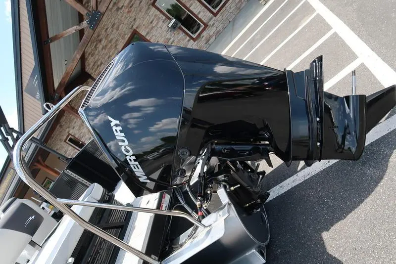 Slide: The Image of 2025 Bennington S Swingback 22 SSB with Mercury outboard motor in parking lot. - 10