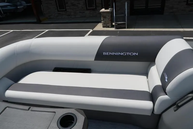 Slide: The Image of 2025 Bennington S Swingback 22 SSB boat seating, featuring sleek gray and white upholstery. - 11