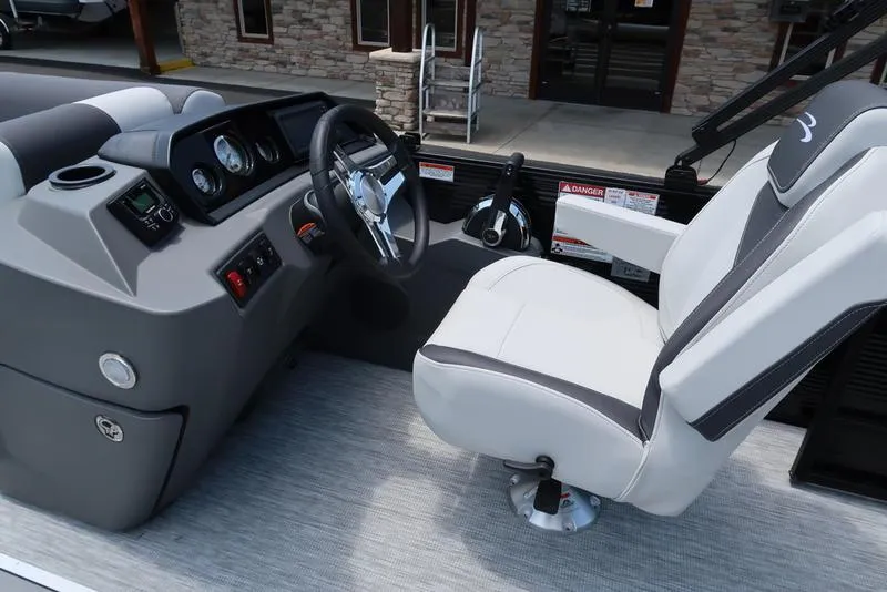 Slide: The Image of 2025 Bennington S Swingback 22 SSB boat interior with steering wheel and captain's chair. - 19